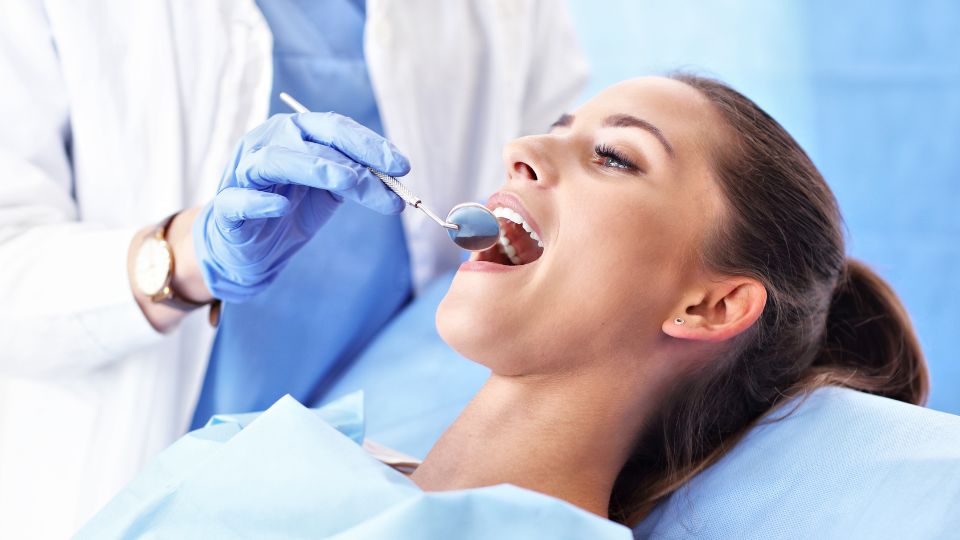 A Woman Seated on a Dental Chair For A Root Canal Treatment