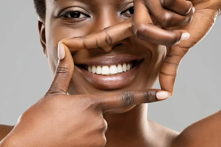 Woman Framing Her Perfect White Teeth With Fingers