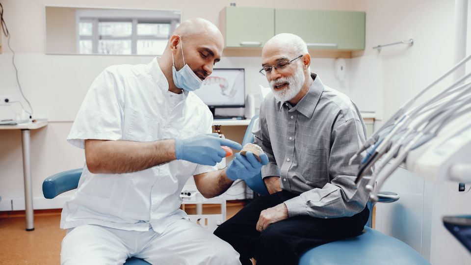 Dentist Explaining Oral Health To A Senior Patient