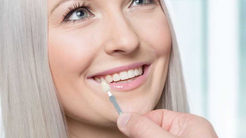 Woman Getting Veneer Matched To Tooth Shade