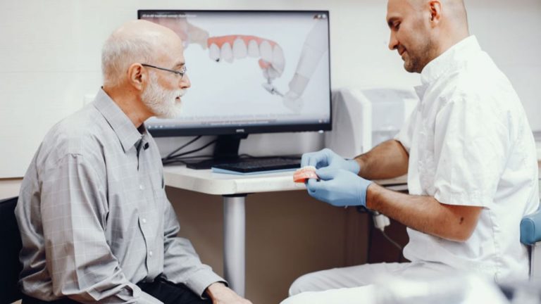 Elderly Patient And A Dentist Talking